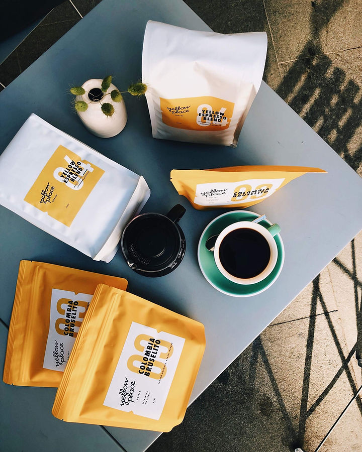 White and yellow coffee bags with degassing valves that are best for shipping.