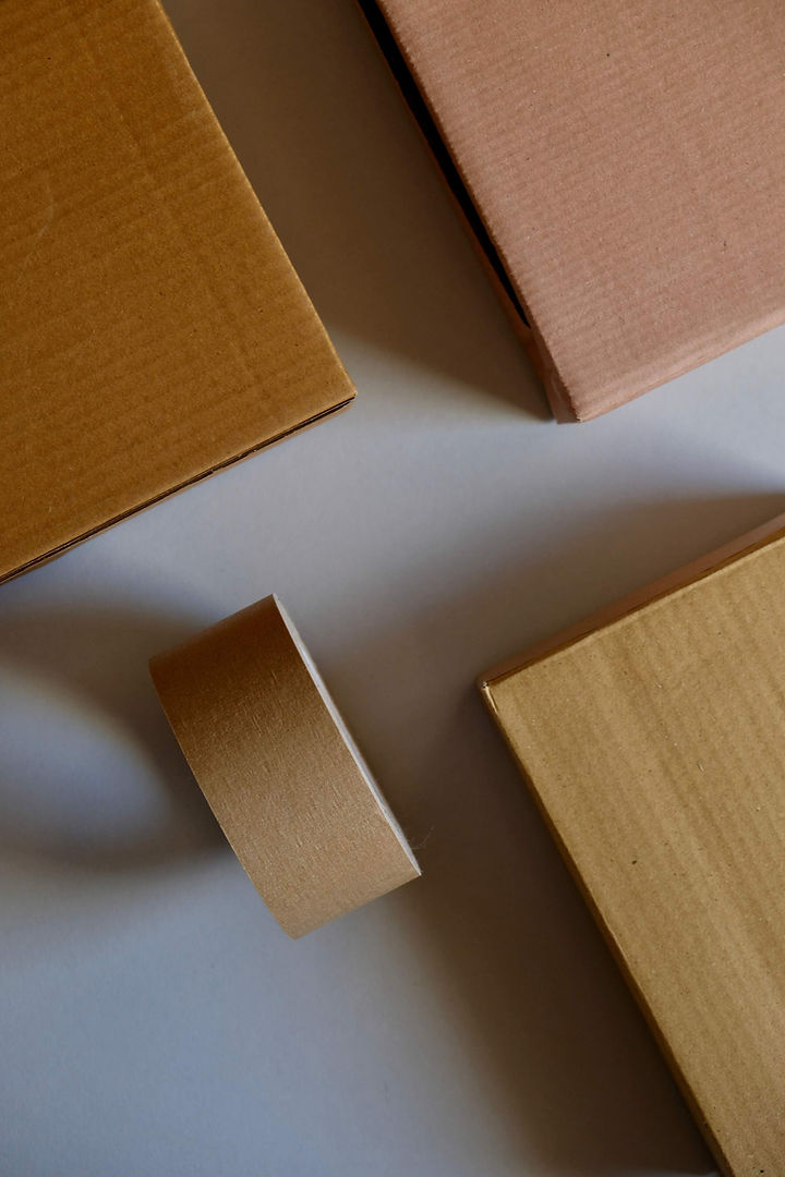 Beige flat-rate shipping boxes with beige tape. 